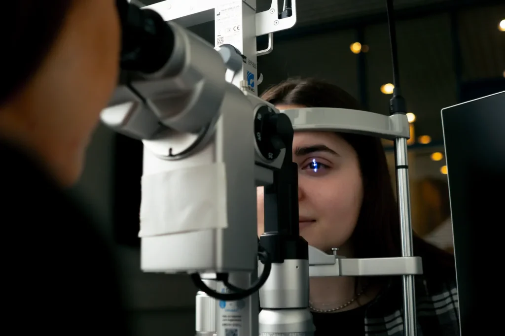Optometrista realizando diagnóstico visual con foróptero durante jornada corporativa